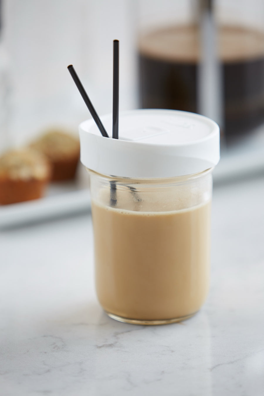 Iced coffee in a mason jar with an iLids drink lid and straws